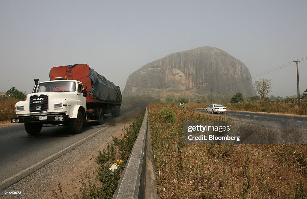 A truck passes by Zuma Rock, a landmark in Abuja, Nigeria, T