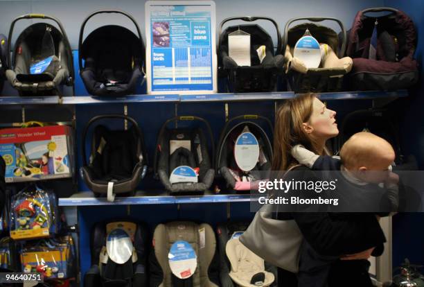 Woman with a young child browses at a Mothercare outlet in Oxford Street, central London, Friday, May 19, 2006. Mothercare Plc, a U.K. Retailer of...