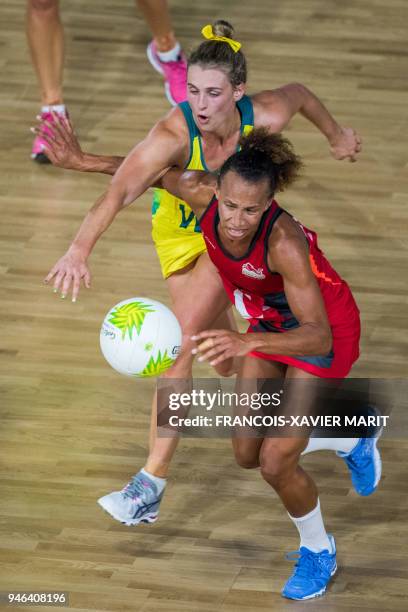 Australia's Gabi Simpson and England's Serena Guthrie compete for the bale during their women's field netball gold medal match of the 2018 Gold Coast...