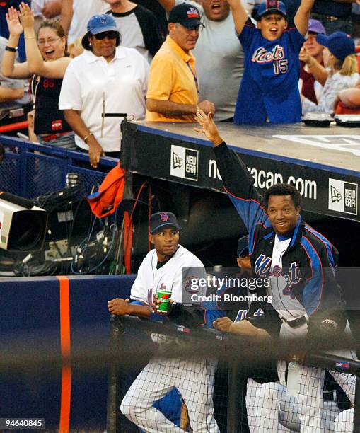 Injured Mets pitcher Pedro Martinez waves to fans during game 1 of the National League Division Series between the New York Mets and the Los Angeles...