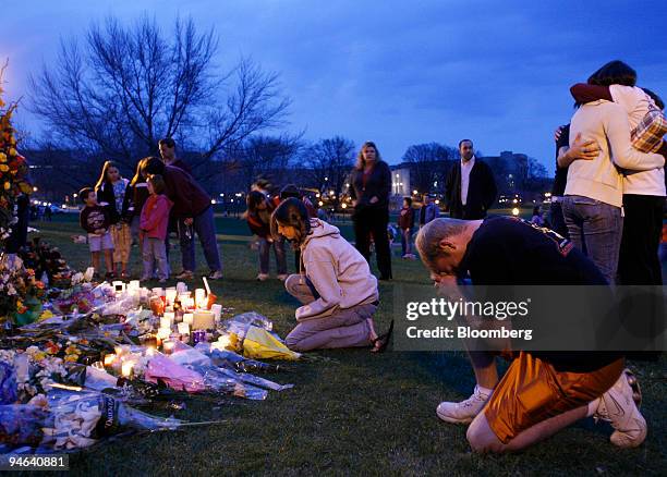 Mourners pray at a memorial across from Burruss Hall at Virginia Tech University, on Wednesday, April 18 in Blacksburg, Virginia. The Virginia Tech...