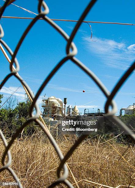 The Ord Sugar Refinery is seen through a fence in Kununurra, Western Australia, on Tuesday, June 5, 2007. Negotiations on weather the refinery will...