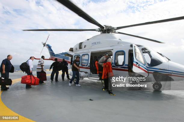 Contract workers board a Chevron Corp. Helicopter during a shift-change on Discoverer Deep Seas, a Transocean deepwater drill ship, Monday, December...