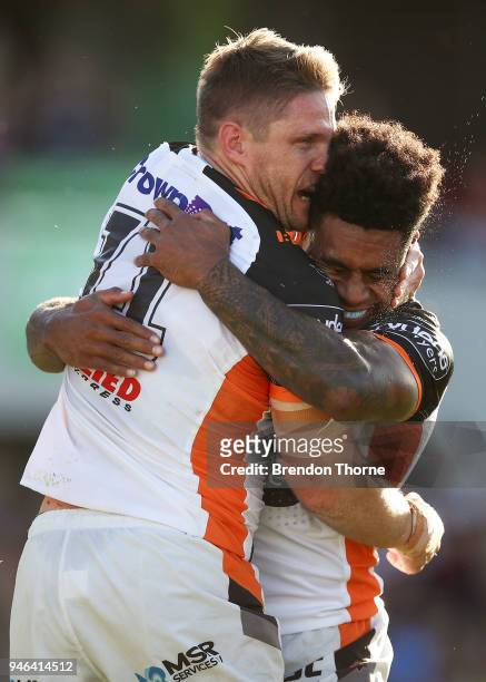 Christopher Lawrence of the Tigers celebrates with team mate Kevin Naiqama after scoring a try during the round six NRL match between the Manly Sea...