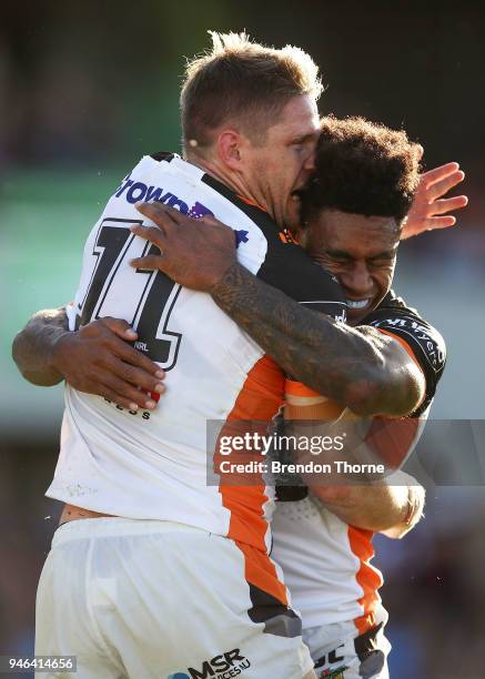 Christopher Lawrence of the Tigers celebrates with team mate Kevin Naiqama after scoring a try during the round six NRL match between the Manly Sea...