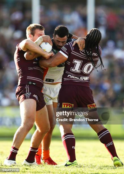 Ben Matulino of the Tigers is tackled by the Sea Eagles defence during the round six NRL match between the Manly Sea Eagles and the Wests Tigers at...