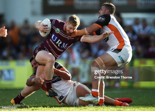 Bradley Parker of the Sea Eagles is tackled by the Tigers defence during the round six NRL match between the Manly Sea Eagles and the Wests Tigers at...