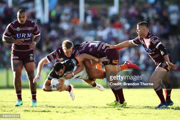 Ben Matulino of the Tigers is tackled by the Sea Eagles defence during the round six NRL match between the Manly Sea Eagles and the Wests Tigers at...