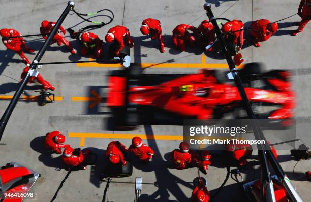 Kimi Raikkonen of Finland driving the Scuderia Ferrari SF71H makes a pit stop for new tyres during the Formula One Grand Prix of China at Shanghai...