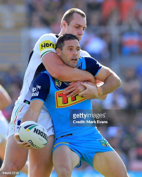 Michael Gordon of the Titans is tackled by Isaac Yeo of the Panthers during the round six NRL match between the Penrith Panthers and the Gold Coast...