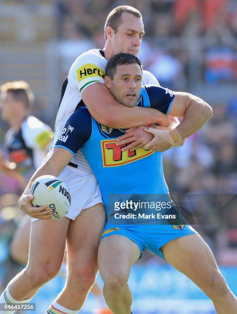 Michael Gordon of the Titans is tackled by Isaac Yeo of the Panthers during the round six NRL match between the Penrith Panthers and the Gold Coast...