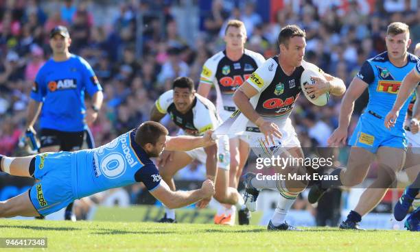 James Maloney of the Panthers is tackled by Max King of the Titans during the round six NRL match between the Penrith Panthers and the Gold Coast...