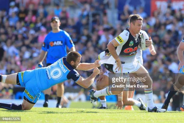 James Maloney of the Panthers is tackled by Max King of the Titans during the round six NRL match between the Penrith Panthers and the Gold Coast...
