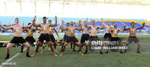 New Zealand players perform the haka after defeating Fiji in the men's rugby sevens gold medal match at the Robina Stadium during the 2018 Gold Coast...