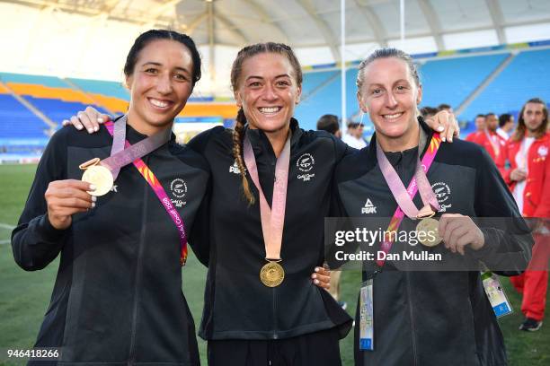 Sarah Goss, Niall Williams and Kelly Brazier of New Zealand pose with their gold medals after the Women's Gold Medal Rugby Sevens Match between...