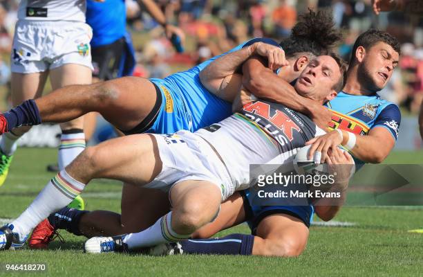 James Maloney of the Panthers is tackled by Ash Taylor and Konrad Hurrell of the Titans during the round six NRL match between the Penrith Panthers...