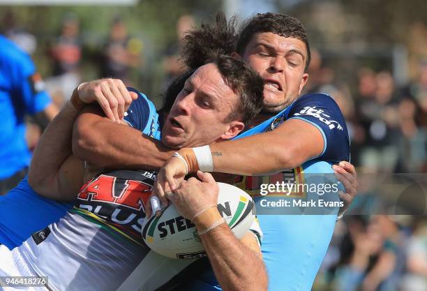 James Maloney of the Panthers is tackled by Ash Taylor and Konrad Hurrell of the Titans during the round six NRL match between the Penrith Panthers...