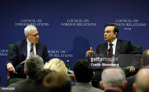 Nissan Motor Co. Chief Executive Officer Carlos Ghosn, right, speaks with David Rubenstein, co-founder and managing director of The Carlyle Group, at...