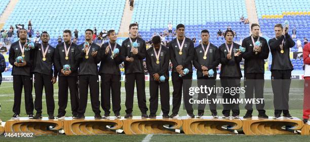 New Zealand players celebrate after defeating Fiji in the men's rugby sevens gold medal match at the Robina Stadium during the 2018 Gold Coast...