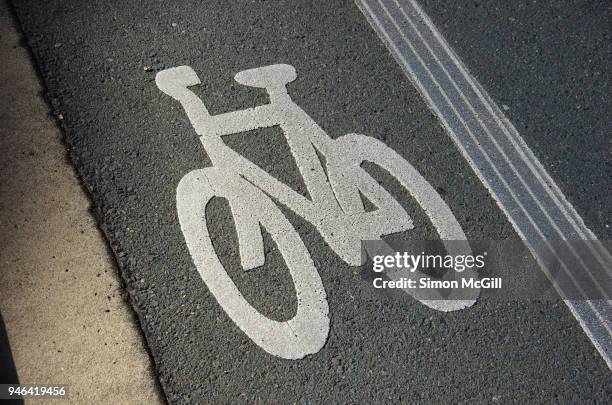 bicycle lane painted on a road - bicycle lane stock pictures, royalty-free photos & images