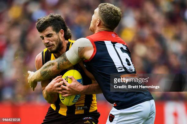 Ben Stratton of the Hawks is tackled by Dean Kent of the Demons during the round four AFL match between the Hawthorn Hawks and the Melbourne Demons...