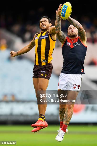 Cyril Rioli of the Hawks and Nathan Jones of the Demons contest the ball during the round four AFL match between the Hawthorn Hawks and the Melbourne...