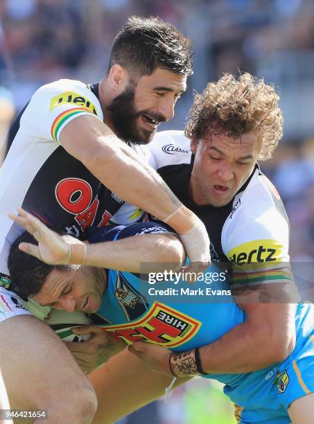 Michael Gordon of the Titans is tackled by James Tamou and James Fisher-Harris of the Panthers during the round six NRL match between the Penrith...