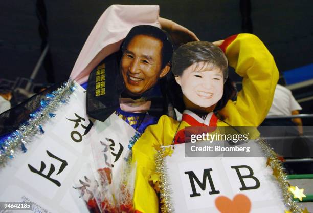 Masked supporters of the Grand National Party pose for photos after the preliminary president election vote in Seoul, South Korea, on Monday, Aug....