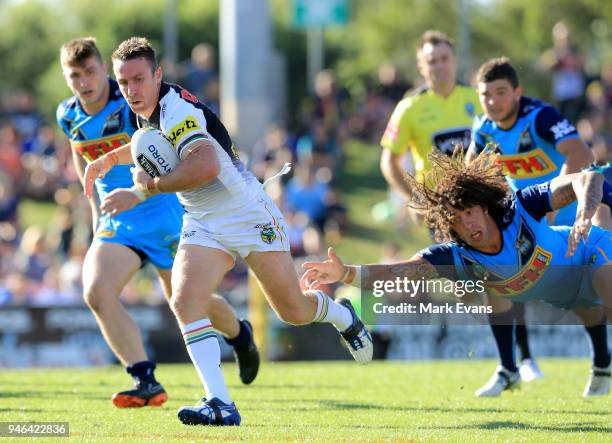 James Maloney of the Panthers gets away from the grasp of Kevin Proctor of the Titansduring the round six NRL match between the Penrith Panthers and...