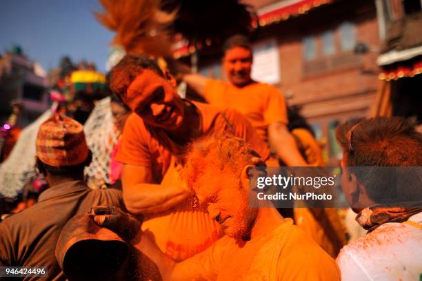 Nepalese devotee applying vermillion powder towards his friends during the celebration of &quot;Sindoor Jatra&quot; vermillion powder festival as...