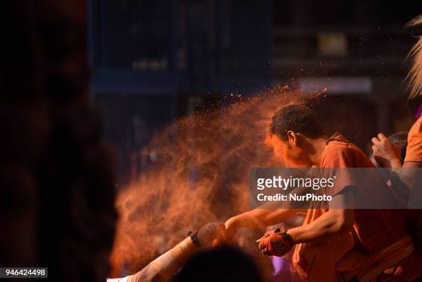 Nepalese devotee spreading vermillion powder towards his friends during the celebration of &quot;Sindoor Jatra&quot; vermillion powder festival as...