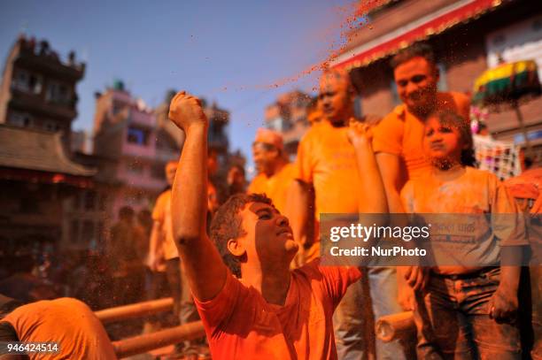 Nepalese devotee spreading vermillion powder towards his friends during the celebration of &quot;Sindoor Jatra&quot; vermillion powder festival as...