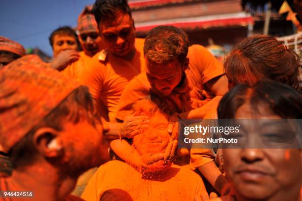 Nepalese devotee applying vermillion powder towards his friends during the celebration of &quot;Sindoor Jatra&quot; vermillion powder festival as...