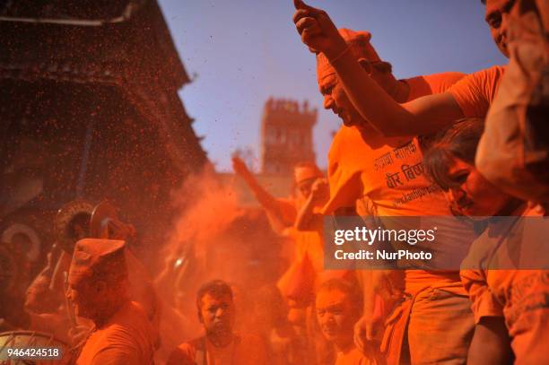 Nepalese devotee spreading vermillion powder towards his friends during the celebration of &quot;Sindoor Jatra&quot; vermillion powder festival as...