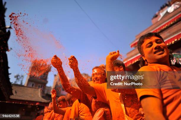 Nepalese devotees spreading vermillion powder towards his friends during the celebration of &quot;Sindoor Jatra&quot; vermillion powder festival as...