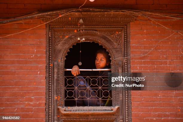 Girl observing the festival during the celebration of &quot;Sindoor Jatra&quot; vermillion powder festival as Nepalese New Year day celebration at...