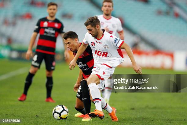 Ben Garuccio of Adelaide challenges Christopher Ikonomidis of the Wanderers during the round 27 A-League match between the Western Sydney Wanderers...