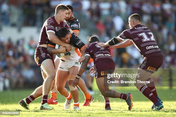 Joshua Aloiai of the Tigers is tackled by the Sea Eagles defence during the round six NRL match between the Manly Sea Eagles and the Wests Tigers at...