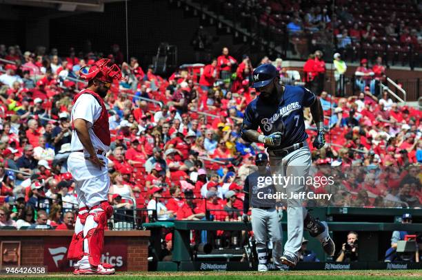 Eric Thames of the Milwaukee Brewers touches home plate after hitting a solo home run during the third inning against the St. Louis Cardinals at...