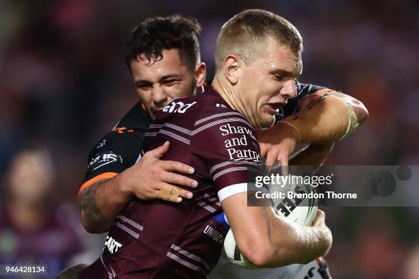 Thomas Trbojevic of the Sea Eagles is tackled by the Tigers defence during the round six NRL match between the Manly Sea Eagles and the Wests Tigers...