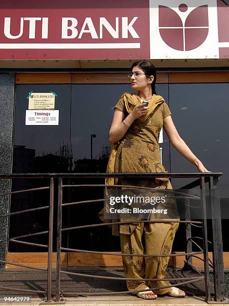 Woman waits outside of a branch of UTI Bank Ltd., in Mumbai, India, on Tuesday, April 17, 2007. UTI Bank Ltd., which makes the lowest provisions for...
