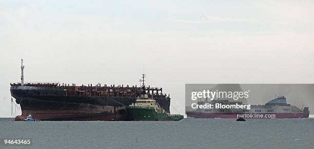 Passenger ferry passes the MSC Napoli the former container ship at the entrance of Belfast Loch, Northern Ireland, Wednesday, Aug. 15, 2007. The...