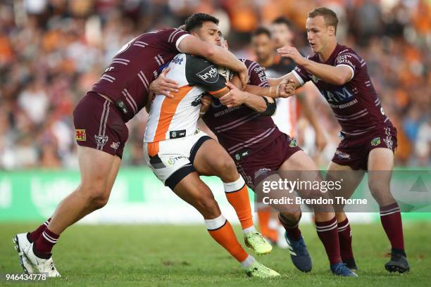 David Nofoaluma of the Tigers is tackled by the Sea Eagles defence during the round six NRL match between the Manly Sea Eagles and the Wests Tigers...