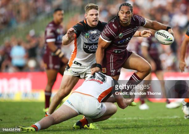 Martin Taupau of the Sea Eagles is tackled by the Tigers defence during the round six NRL match between the Manly Sea Eagles and the Wests Tigers at...
