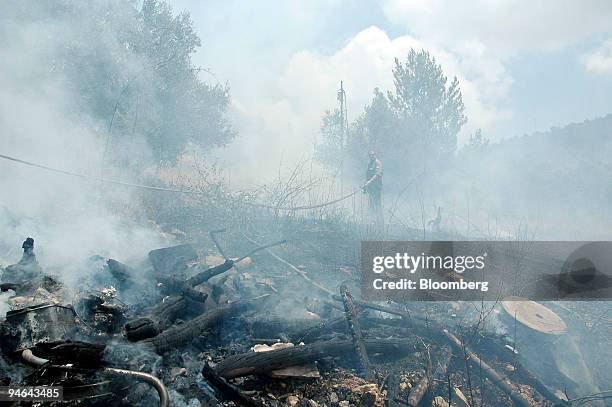 Fire caused by a rockets smolders near the village of Safed, in Upper Galilee, Israel, Friday, July 14, 2006. Israel pounded Hezbollah strongholds in...