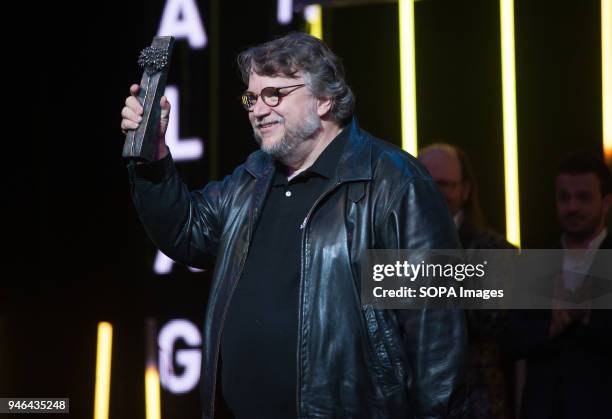 Mexican director Guillermo del Toro holds the 'Málaga-SUR' award as tribute for his professional career inside of the Cervantes Theatre during the...