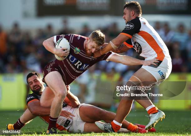 Bradley Parker of the Sea Eagles is tackled by the Tigers defence during the round six NRL match between the Manly Sea Eagles and the Wests Tigers at...