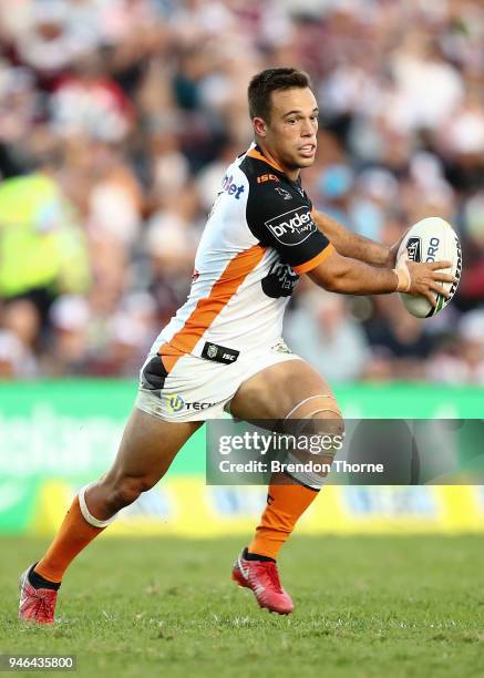 Luke Brooks of the Tigers runs the ball during the round six NRL match between the Manly Sea Eagles and the Wests Tigers at Lottoland on April 15,...