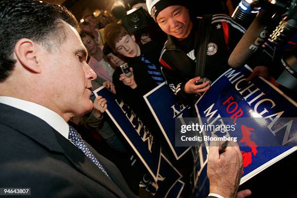 Former Massachusetts Governor Mitt Romney signs a campaign poster after announcing that he will run for President in 2008 at the Henry Ford Museum in...