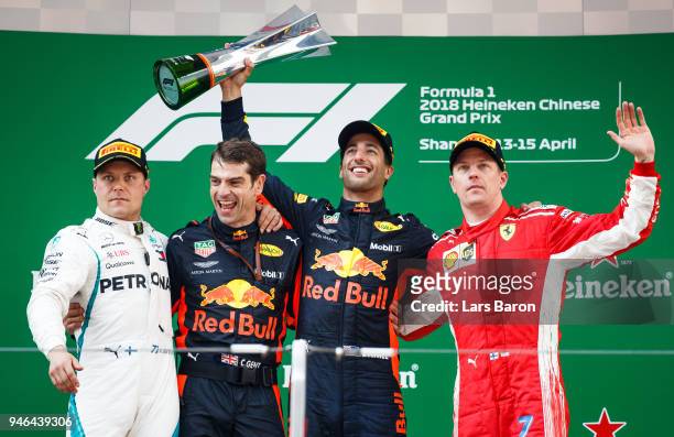 Top three finishers Daniel Ricciardo of Australia and Red Bull Racing, Valtteri Bottas of Finland and Mercedes GP and Kimi Raikkonen of Finland and...